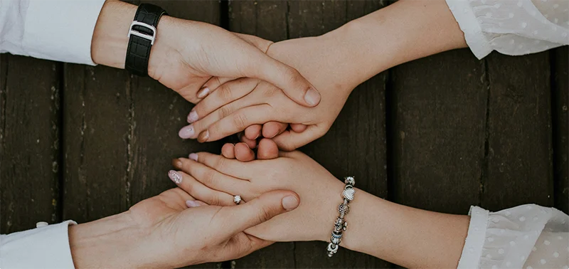 Two people holding hands