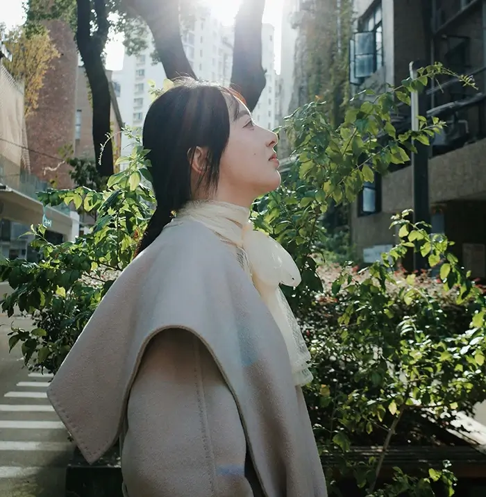 Woman standing outside looking into distance
